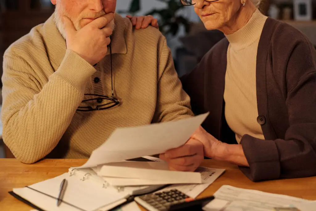 Seniors looking at unpaid financial bill